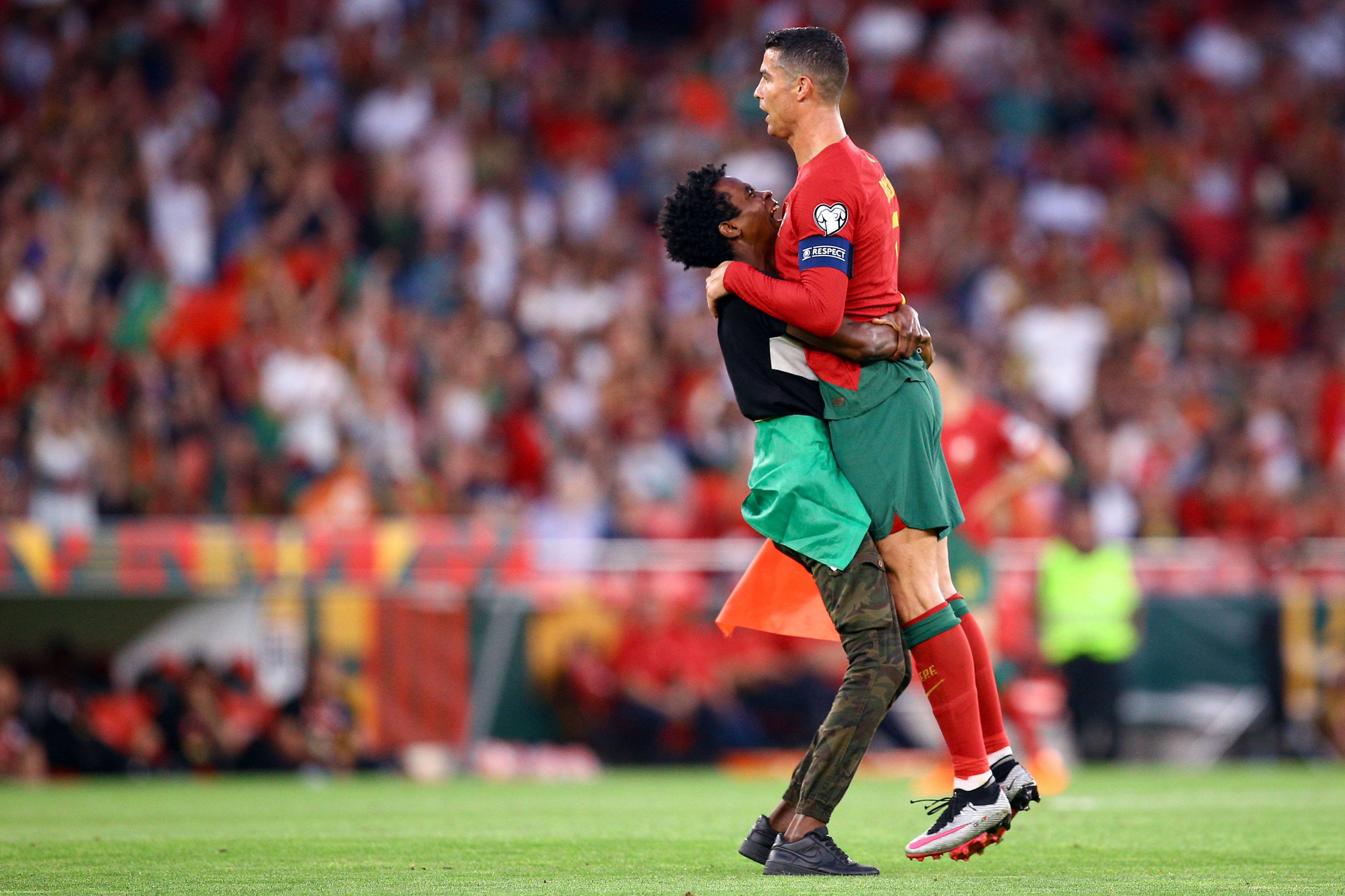 Shocking moment Cristiano Ronaldo is PICKED UP by pitch invader in  disgraceful security breach during Portugal game | The Irish Sun