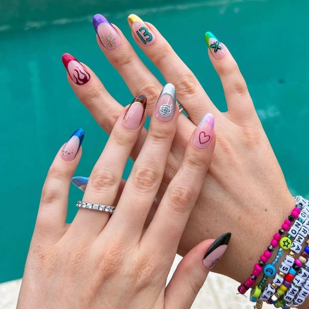 cute mismatched french manicure with designs inspired by different albums for swifties