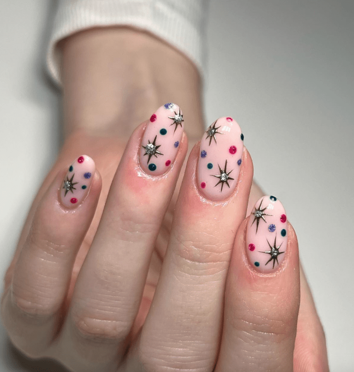 cute new years nails with celestial NYE firework-inspired nail art and rainbow glitter polka dots