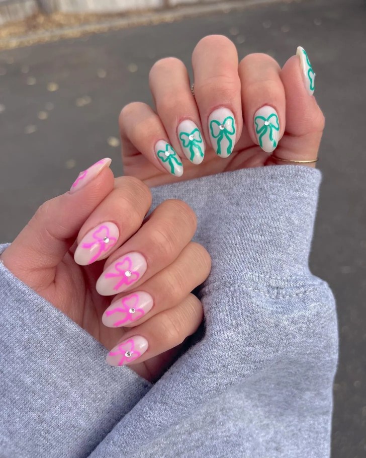 cute new years nails with pink and green bow nail art and rhinestone details