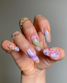 A "more is more" colorful nail art design that was created using blooming gel polish.