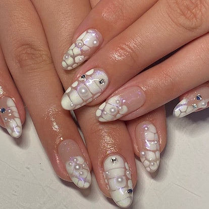 Frosted white croc print nails that were created using blooming gel polish.