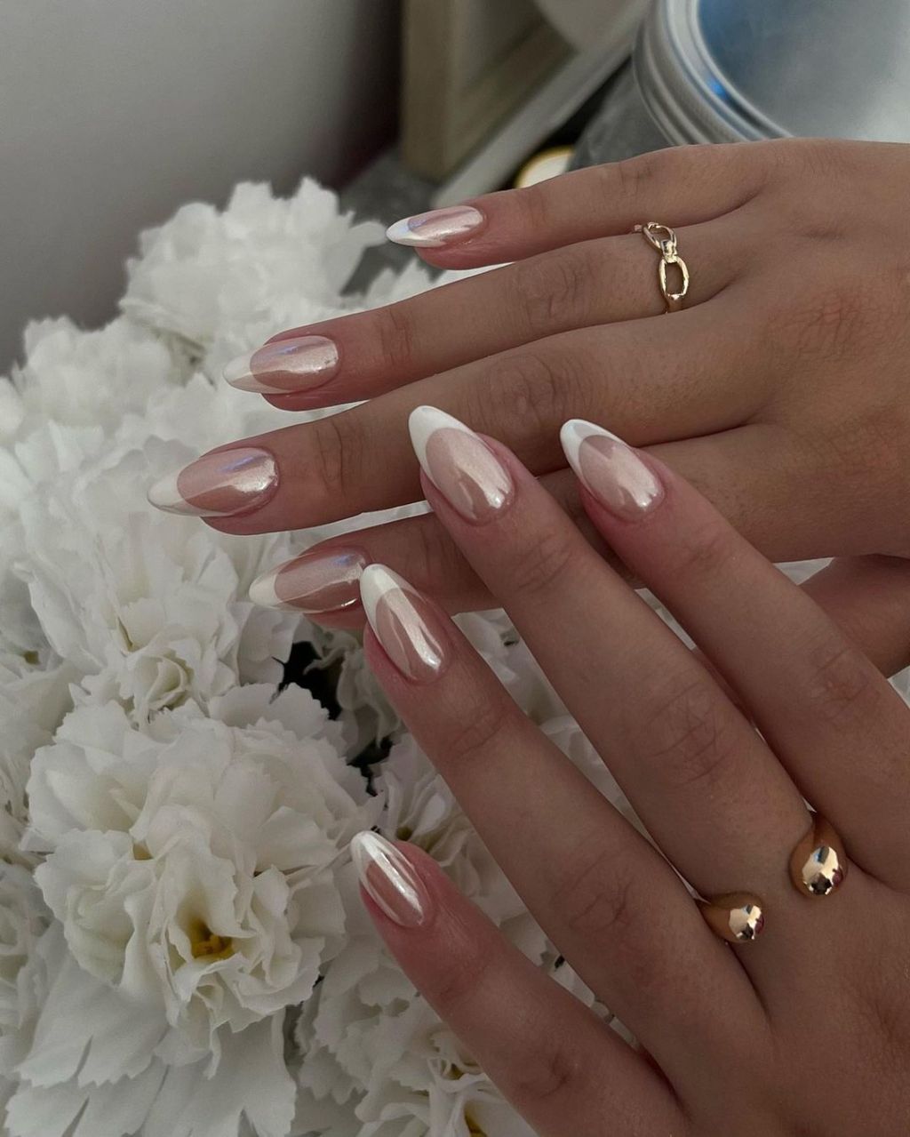 bride displaying her elegant chrome and white french tip wedding nails