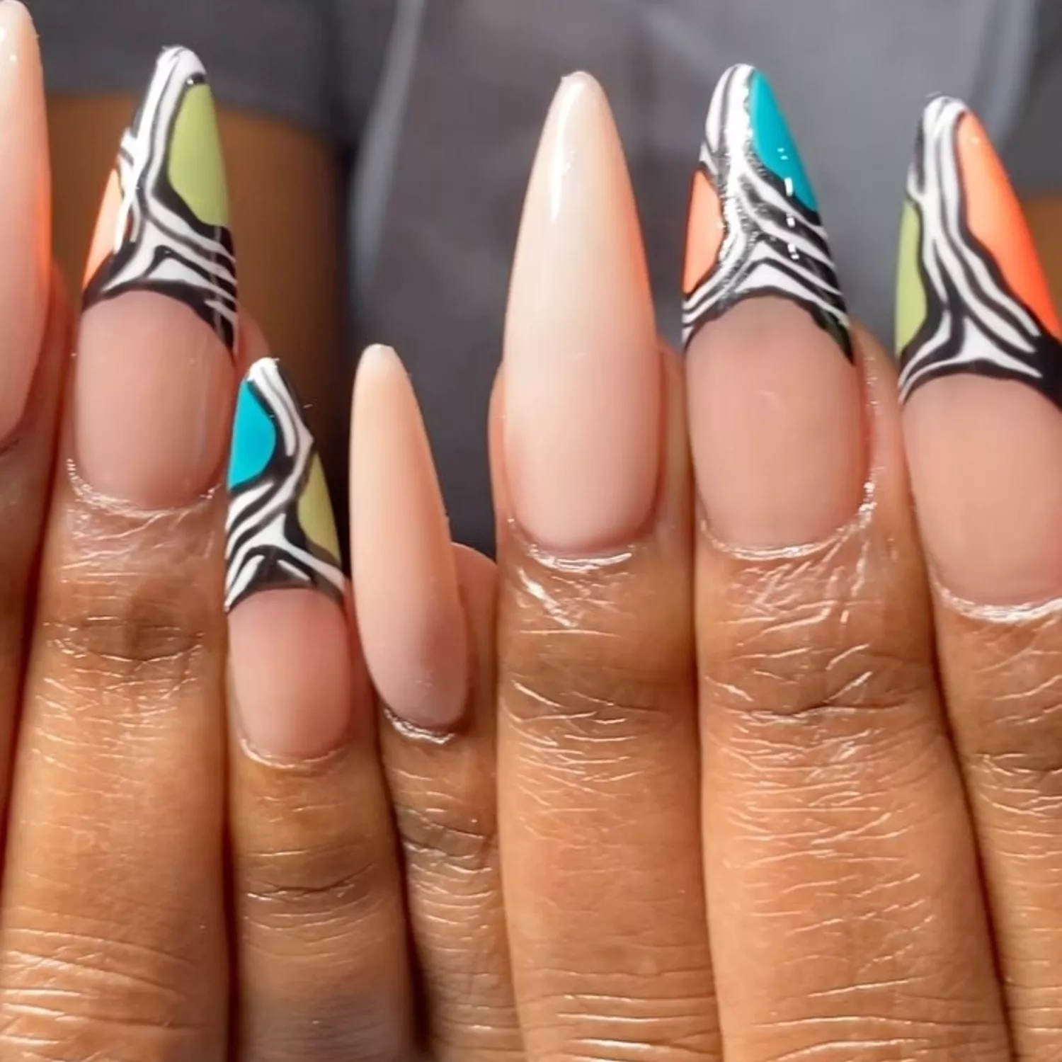 a manicure with black and white ripples on the tips