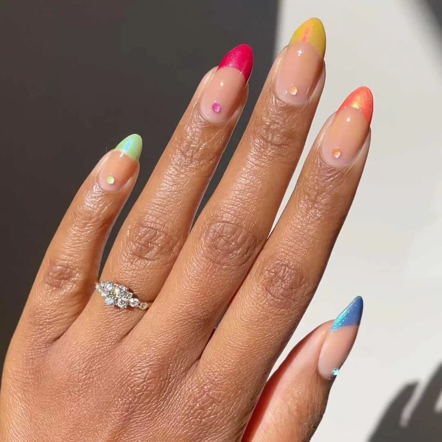 an iridescent skittle french manicure