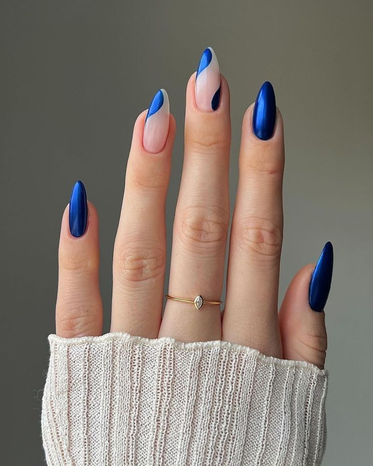 metallic glazed sapphire blue new years nails with cute wavy designs on two fingers