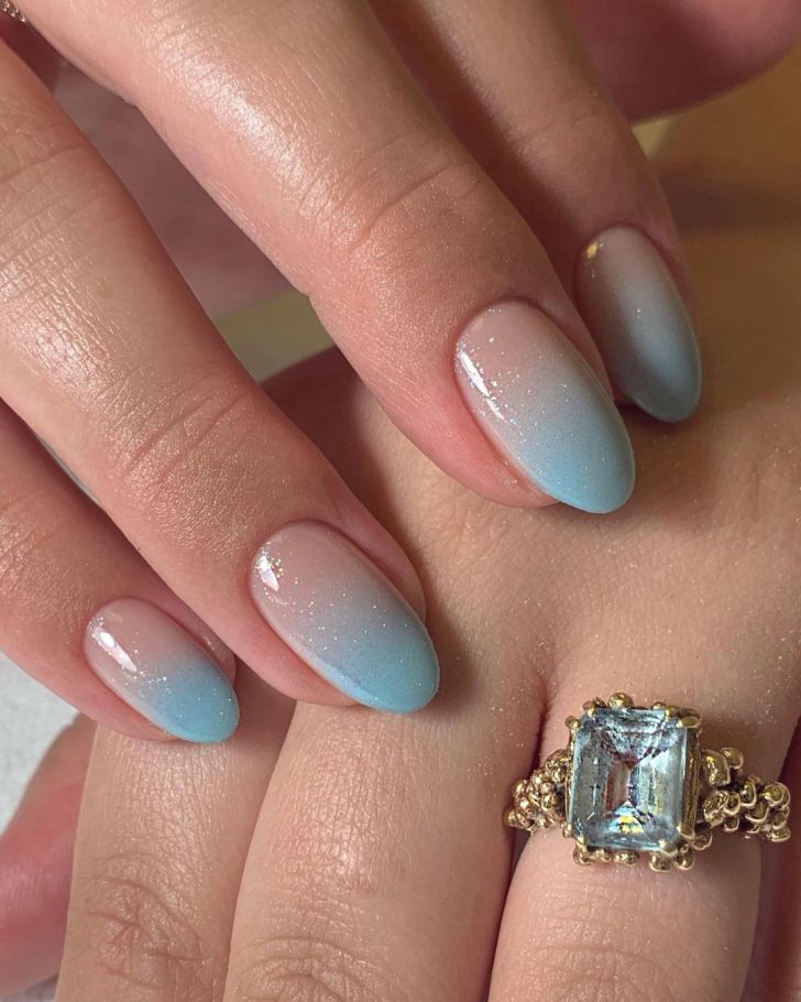 bride wearing glittery baby blue ombre wedding nails