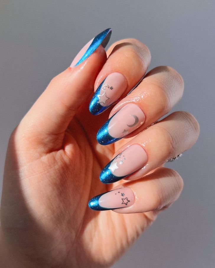 glittery royal blue French tip Taylor Swift Eras tour nails with a celestial silver design inspired by the Midnights album