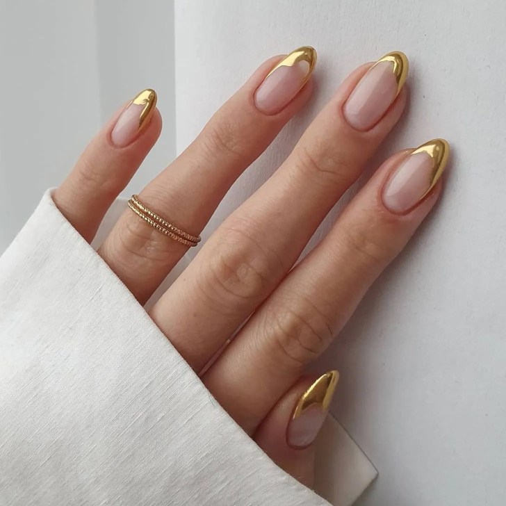 gold tipped manicured nails in a french tip design