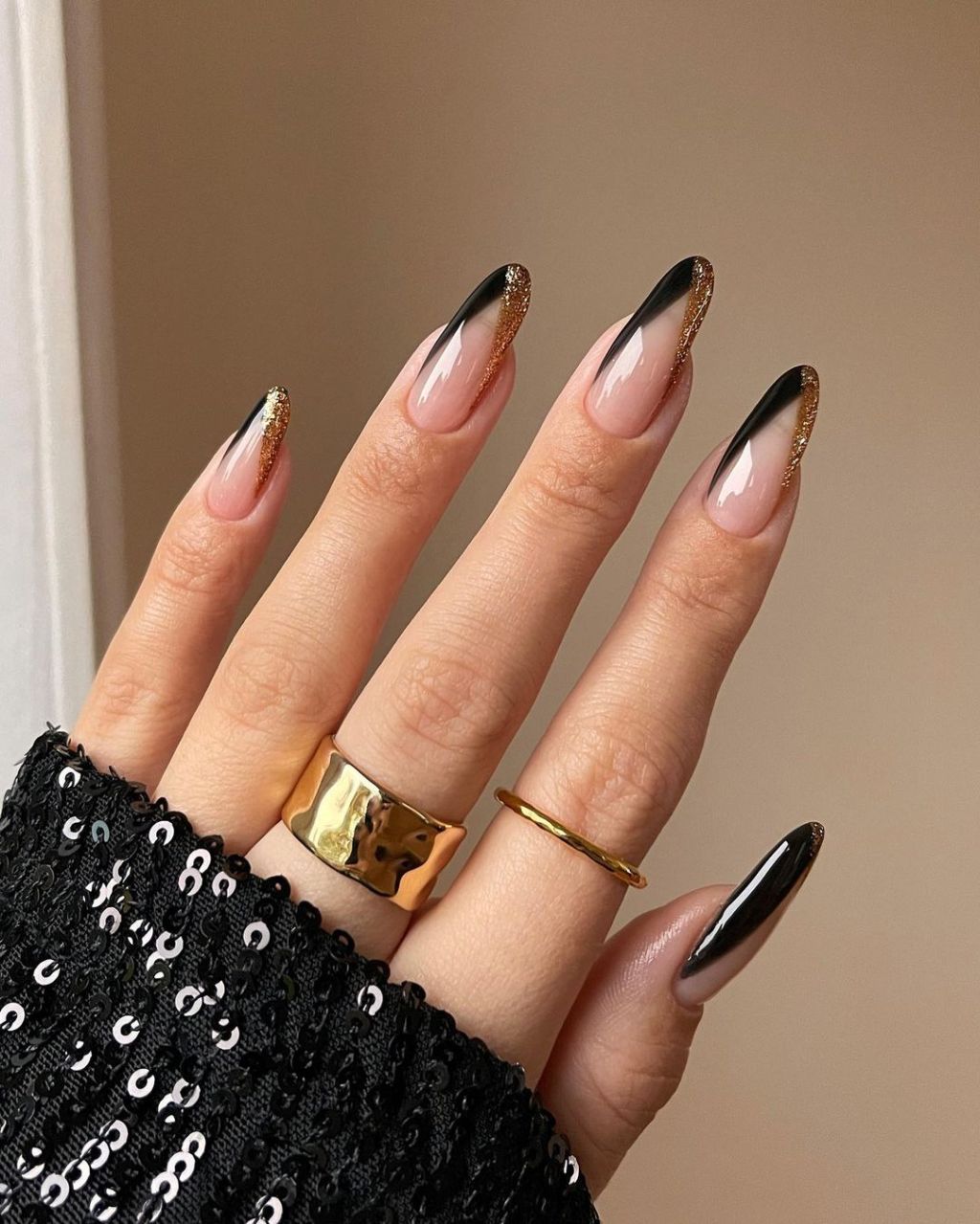 long black and gold new years nails with art deco inspired french tips design