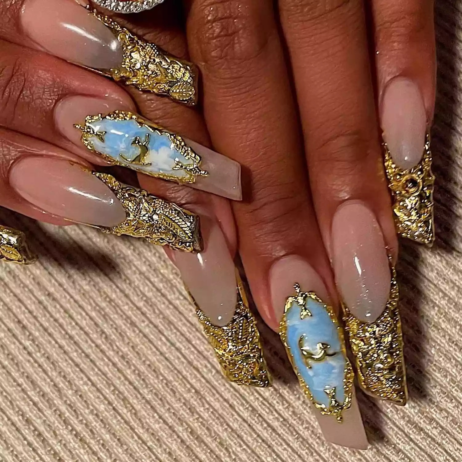 gold and blue nails on megan thee stallion