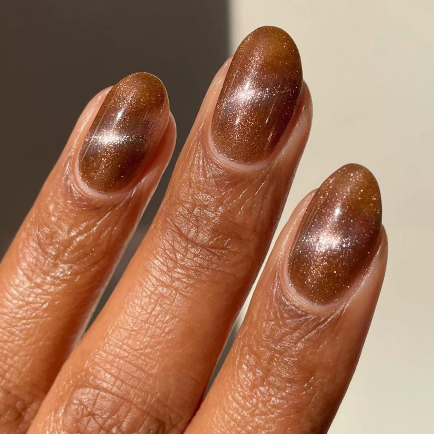 Magnetic brown manicure viewed very close up