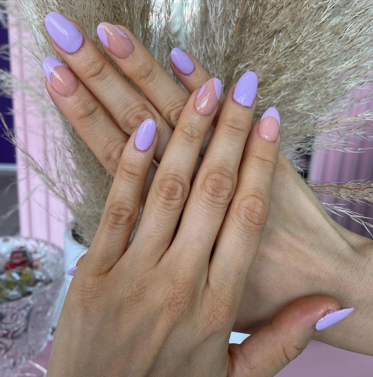 Taylor Swift nails with a mismatched light purple and negative space design inspired by the Speak Now album on the Eras Tour