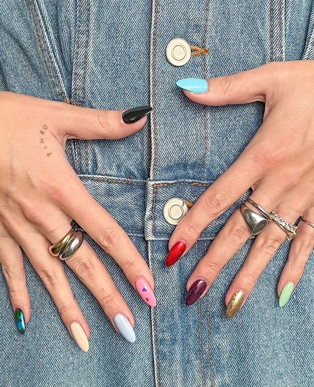 mismatched Taylor Swift nails with a long simple design inspired by each album on the Eras Tour