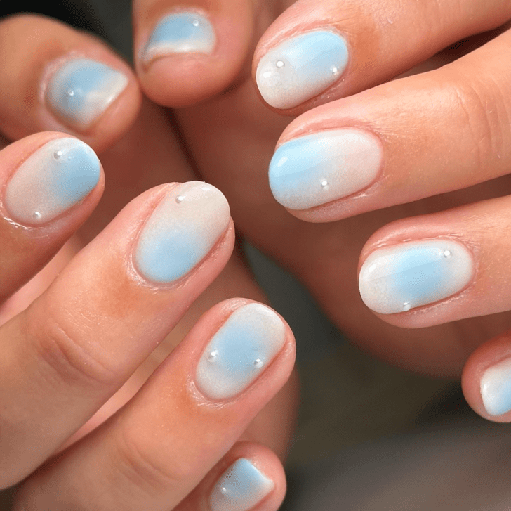 ombre white and light blue Taylor Swift Eras Tour nails with pearl details inspired by the 1989 album