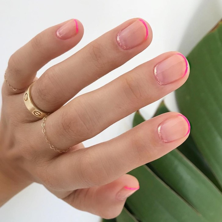 simple nail design with blush hued glitter cuticles and bright hot pink french tips