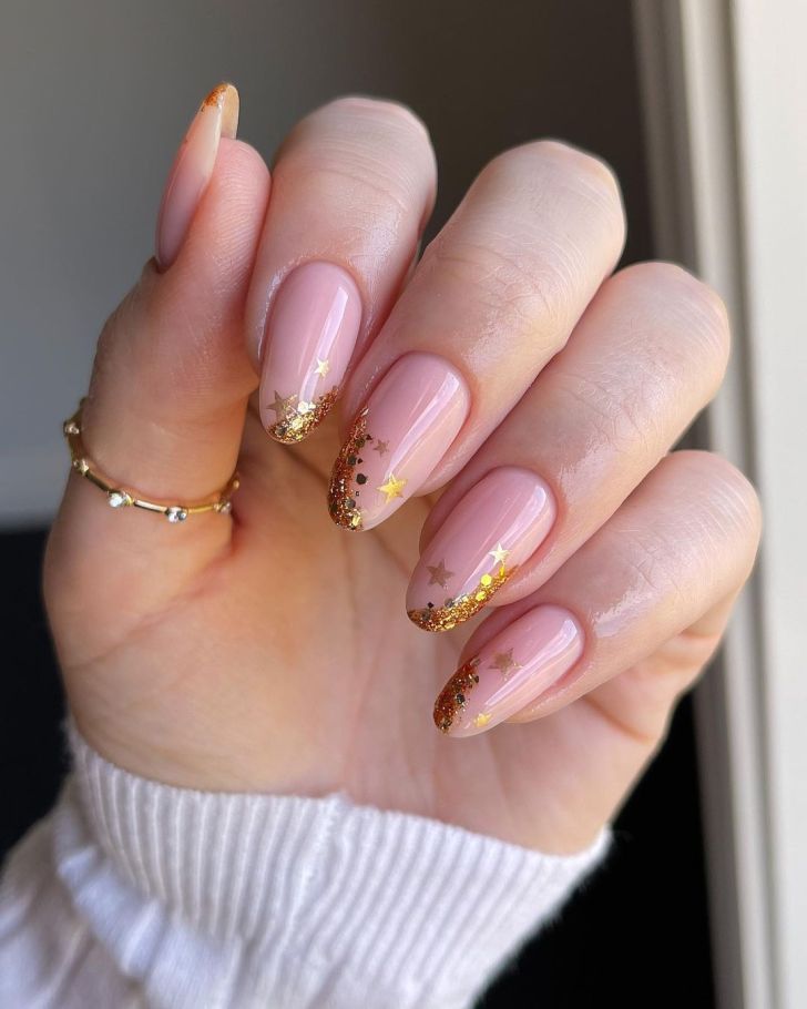 simple glitter gold nye nails with cute confetti star designs