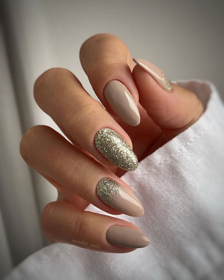 simple nude beige new years nails with ombre glitter gold accents