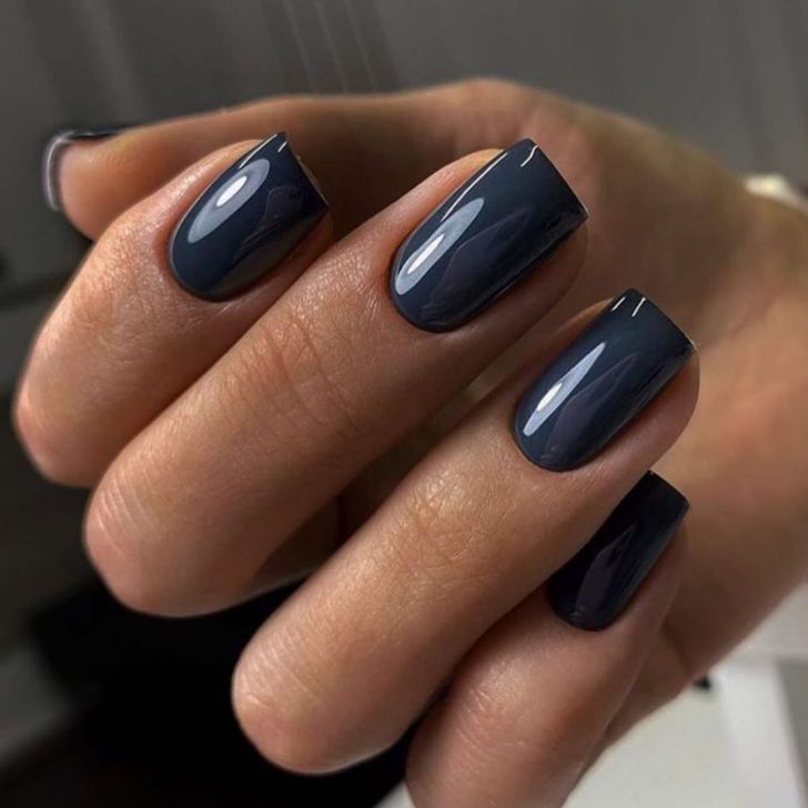 simple square shaped navy blue new years nails with a gel like top coat finish