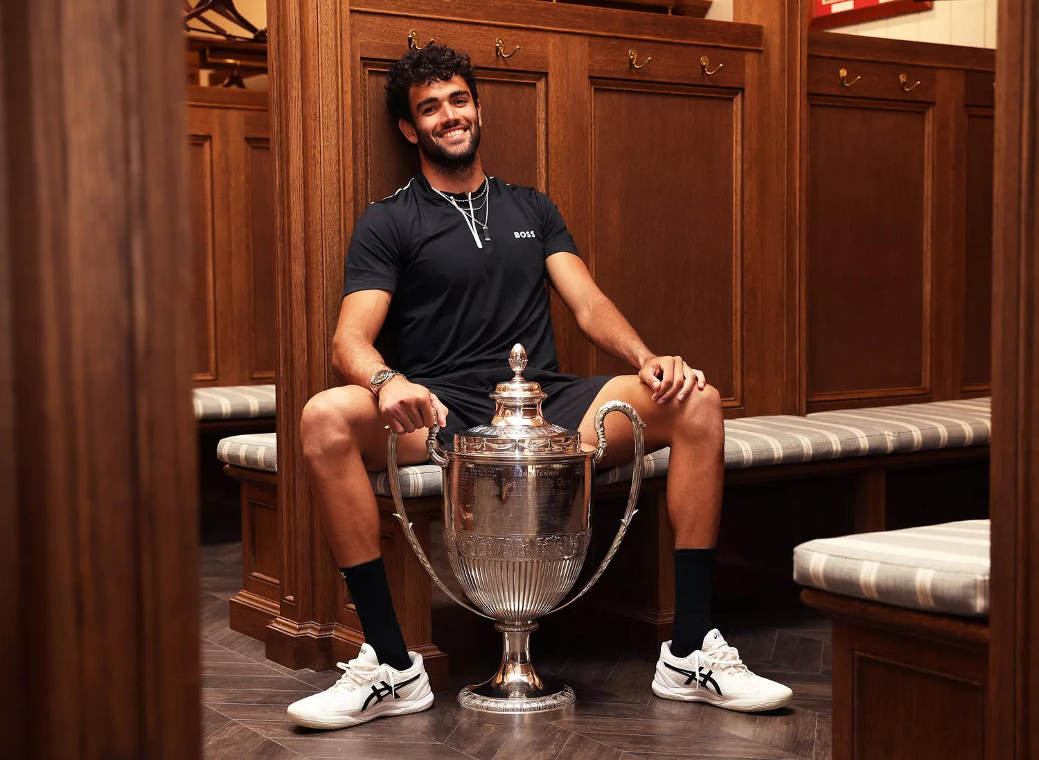 Matteo Berrettini of Italy poses with the trophy in the locker room after winning against Filip Krajinovic of Serbia during the Men's Singles Final match on day seven of the cinch Championships at The Queen's Club on June 19, 2022 in London, England.