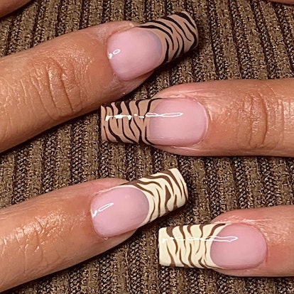 Tonal zebra print French tip nails match the mob wife aesthetic.