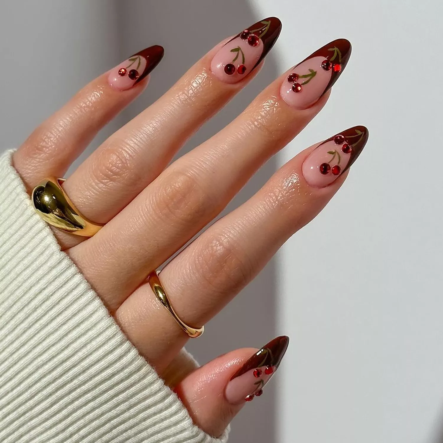 Bedazzled Cherry French Tips - Byrdie Dark Nail Ideas