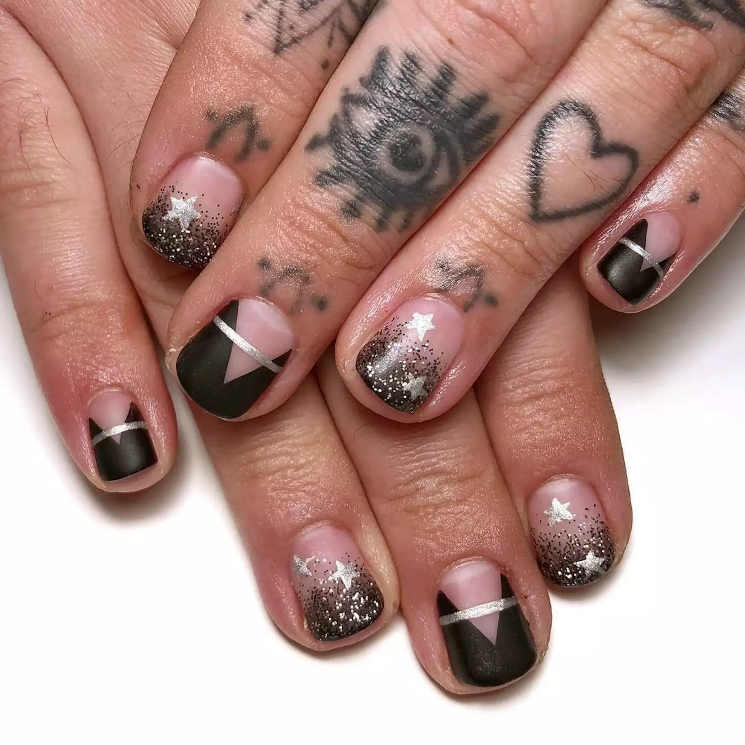 Manicure with black ombre glitter nails and matte black and silver abstract design nails