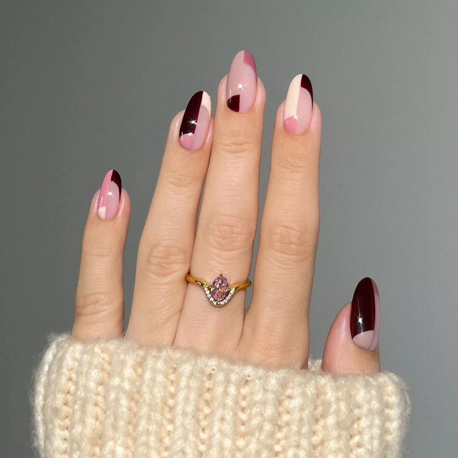 Manicure with brown, pink, and white color block nail design and sparkle details