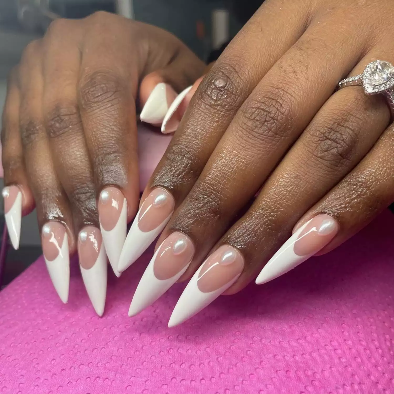 Long, pointy French manicure with pearls and ring