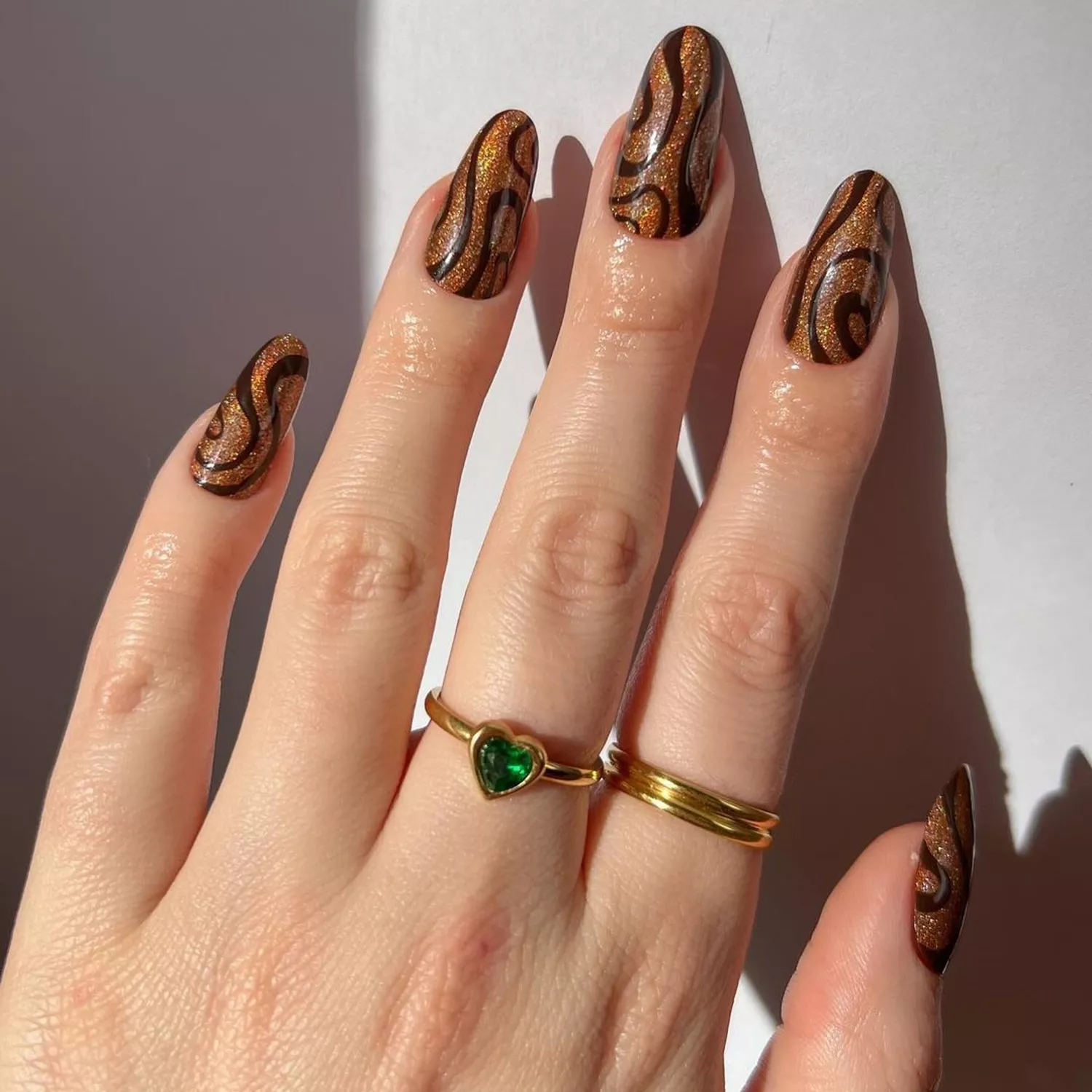 Holographic Chocolate Swirl Nails - Byrdie Dark Nail Ideas