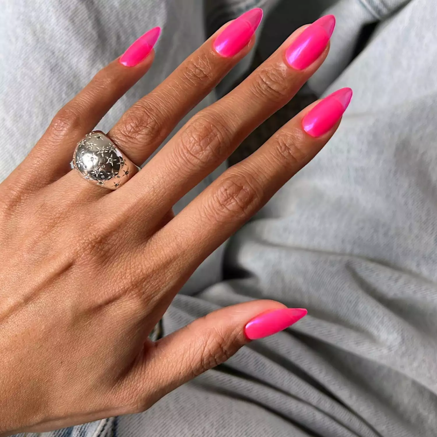 close up of nails in hot pink color with pink chrome