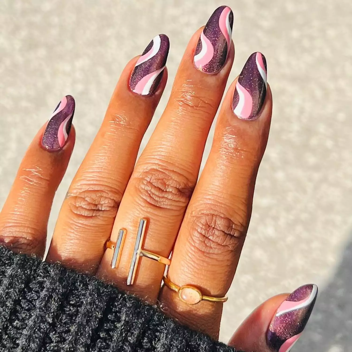 Metallic mauve manicure with swirl accents