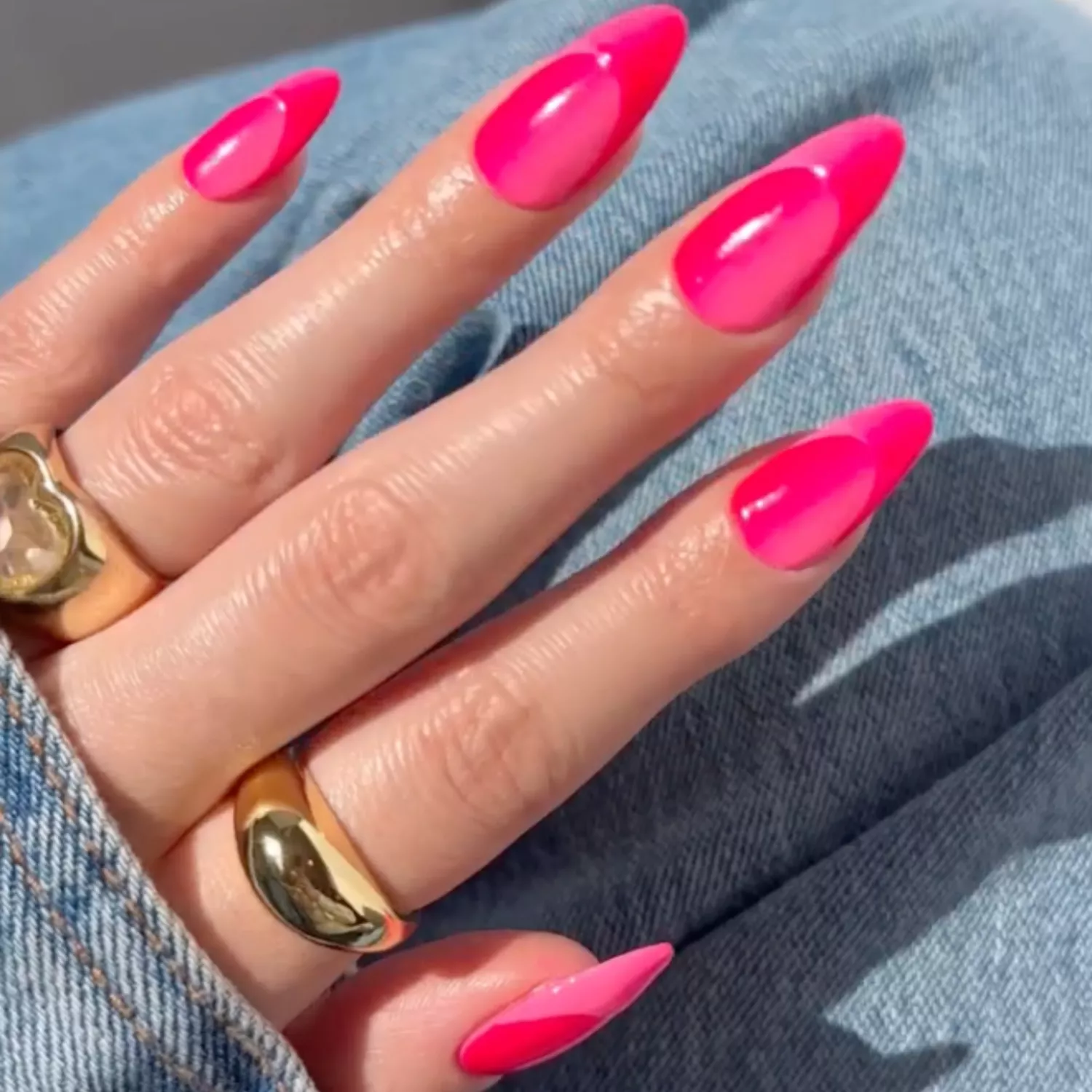 close up of nails with hot pink ombre color and french tip in seamless design