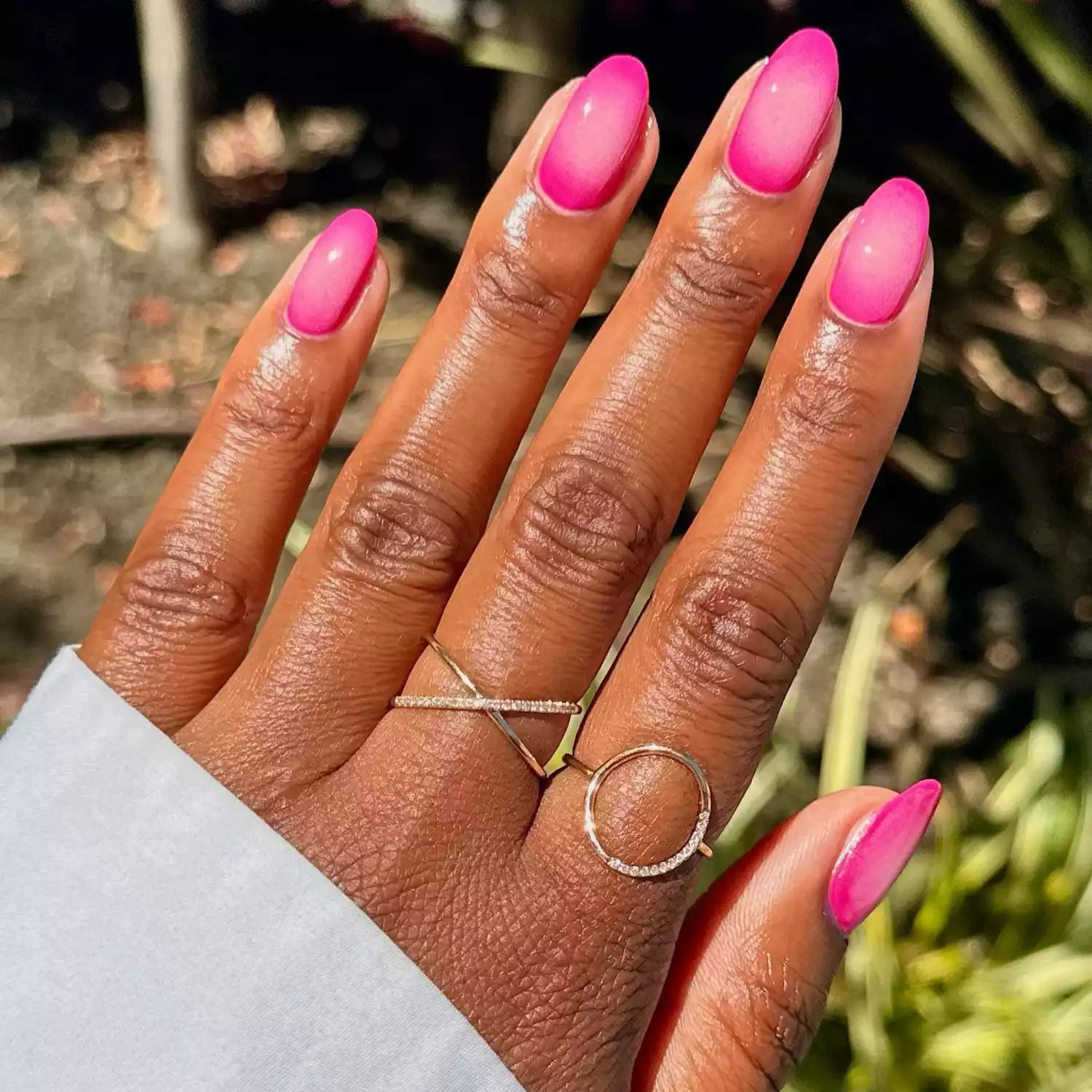 close up of nails with pink ombre aura color