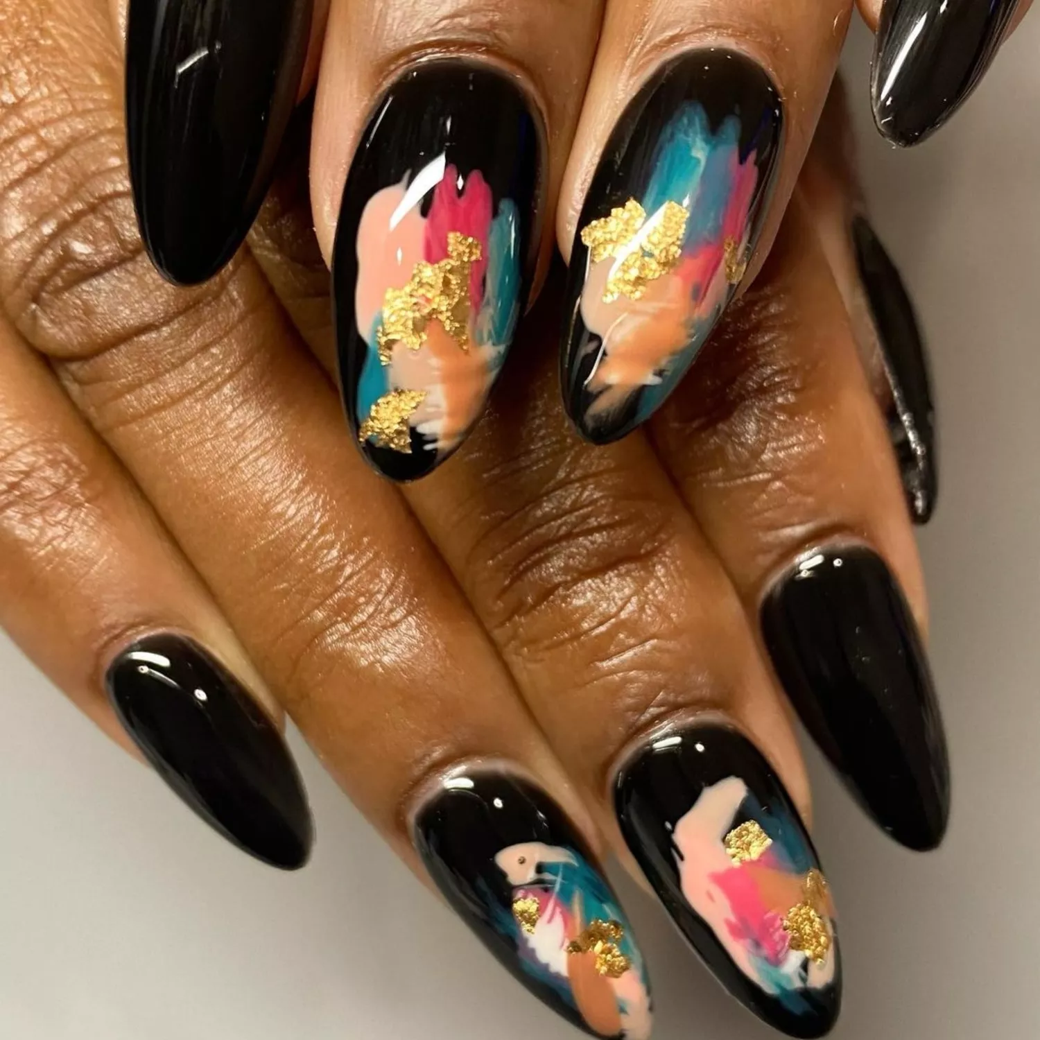 Black glossy nails with abstract art design and gold