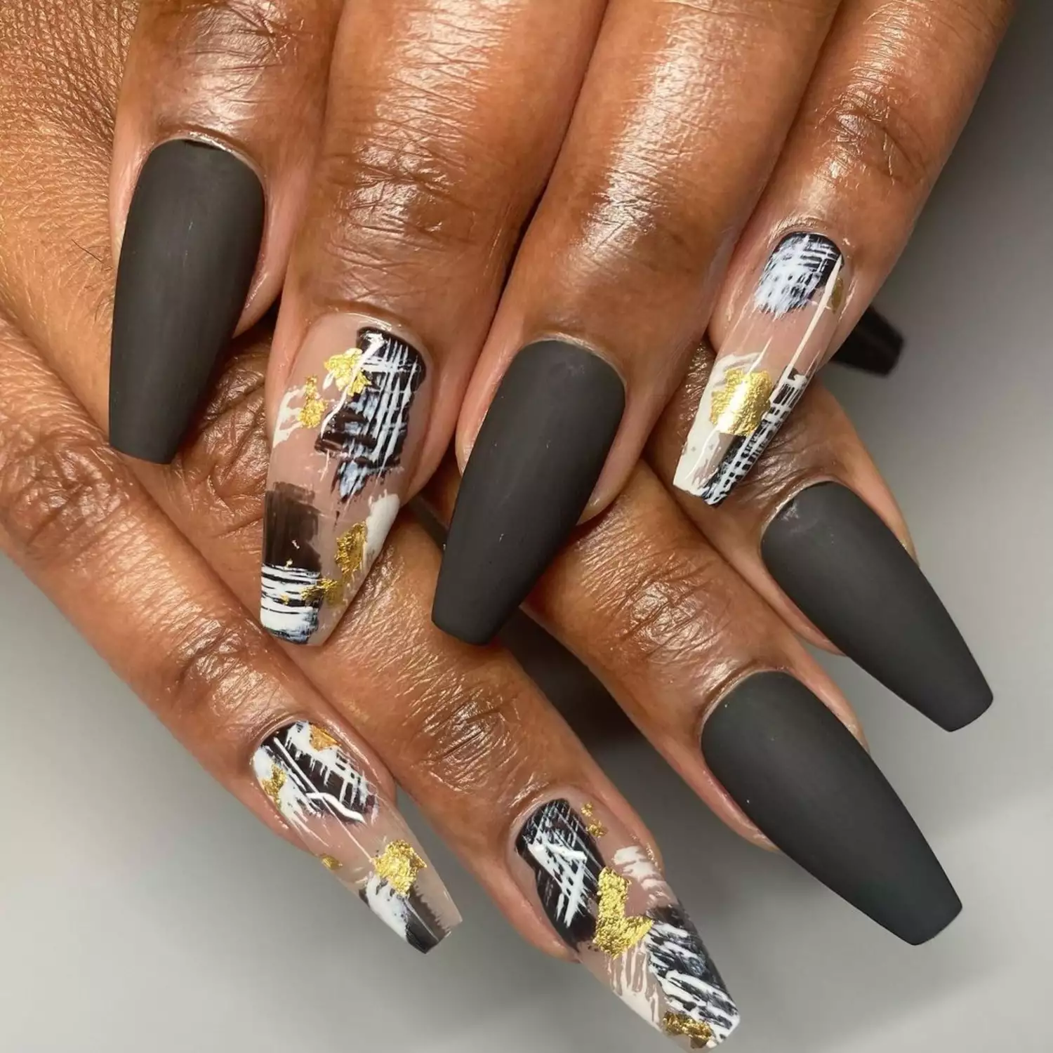 Matte black long nails with gold, black and white abstract art design