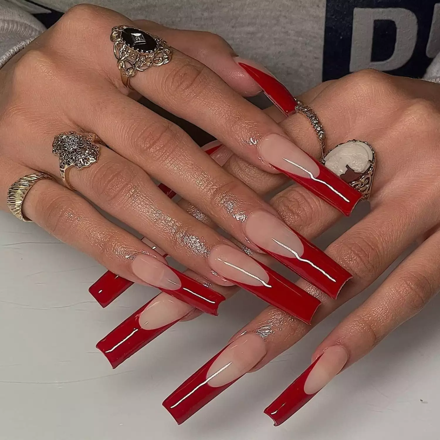 Red tipped extra long nails with rings