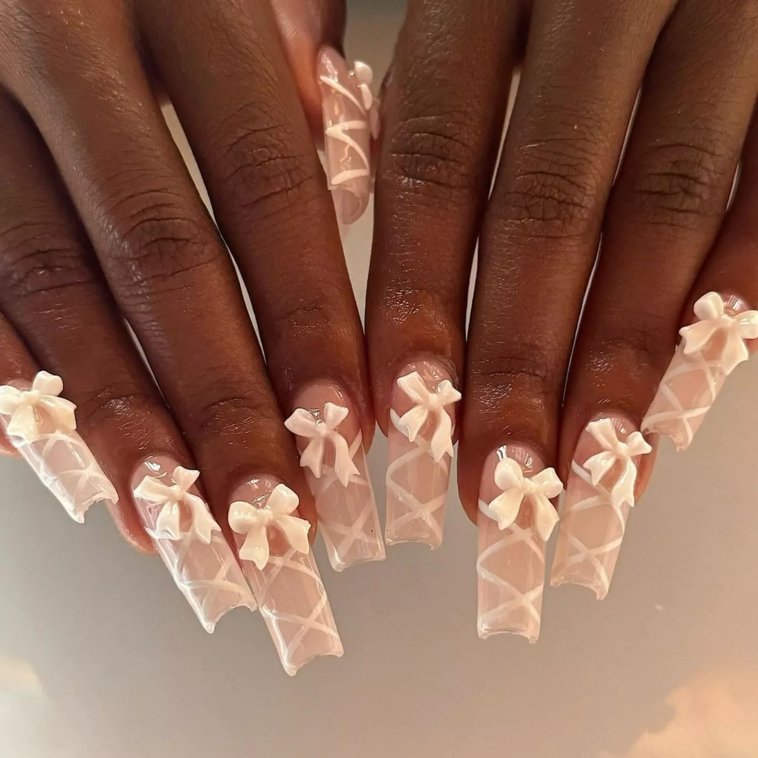 Long square nails with lace-up detail and bows