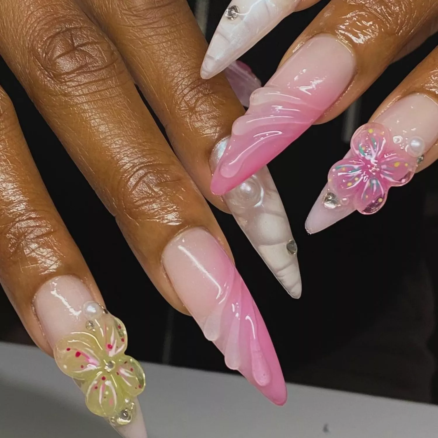 white, pink, and yellow sculpted nails with flowers and rhinestones