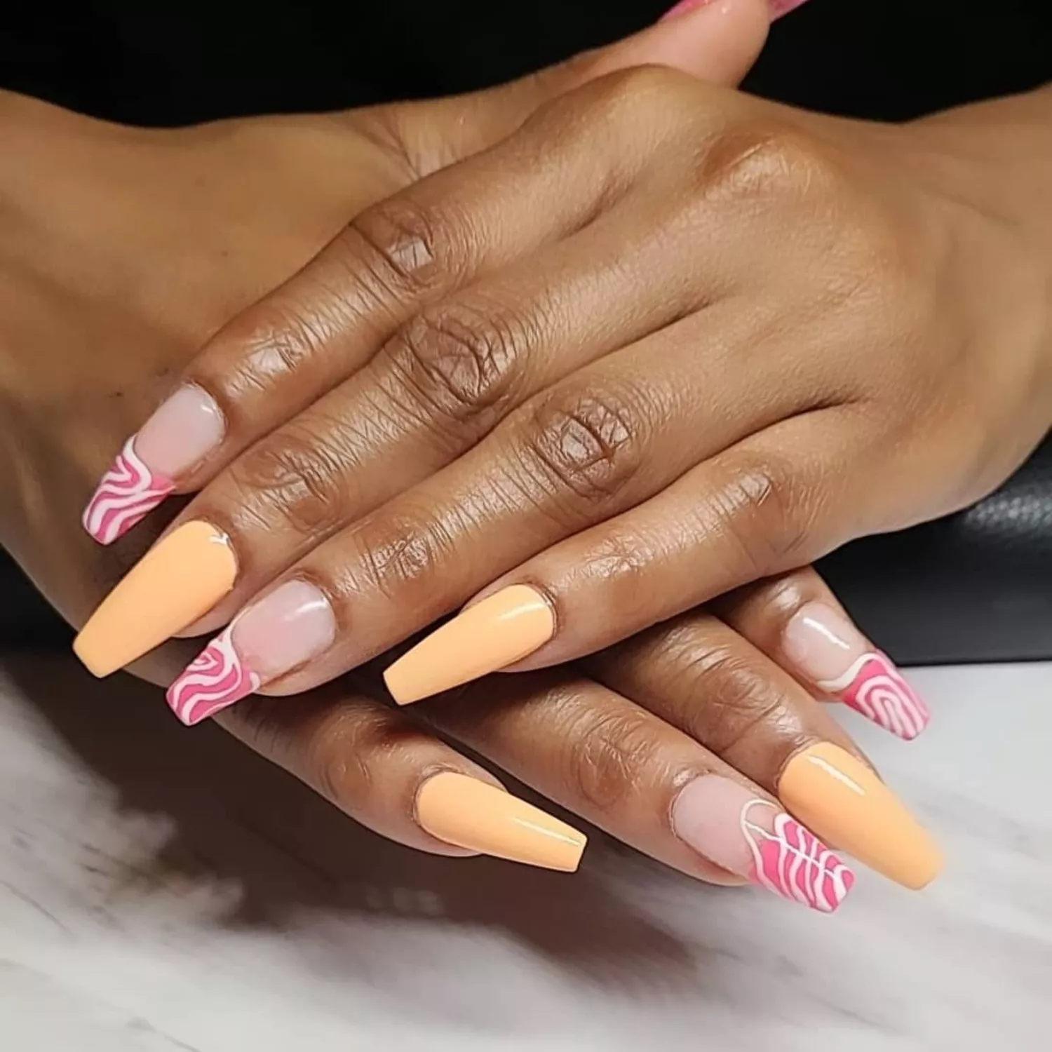 Peach nails with pink swirl tips