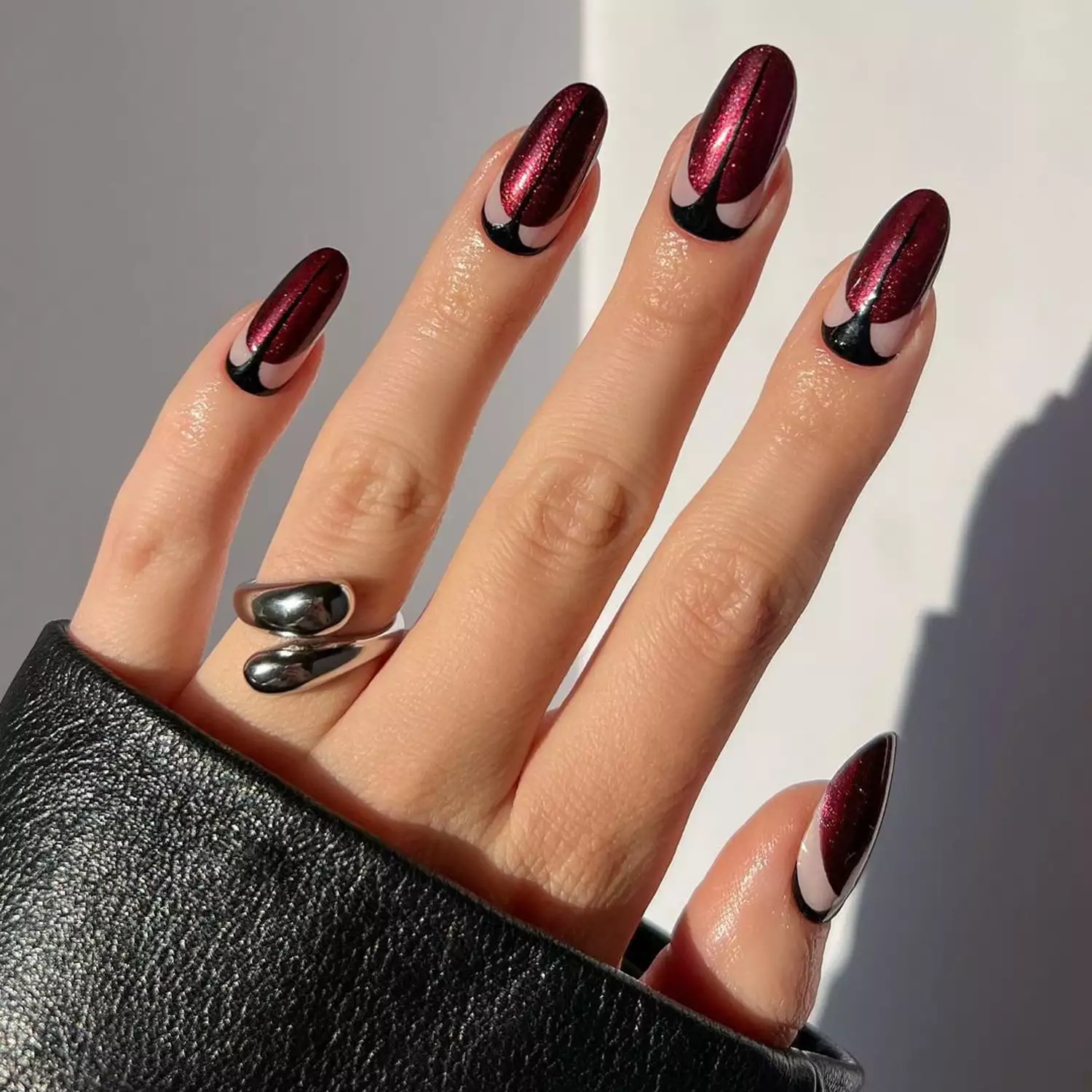 Manicure with black and burgundy shimmer art deco nail design