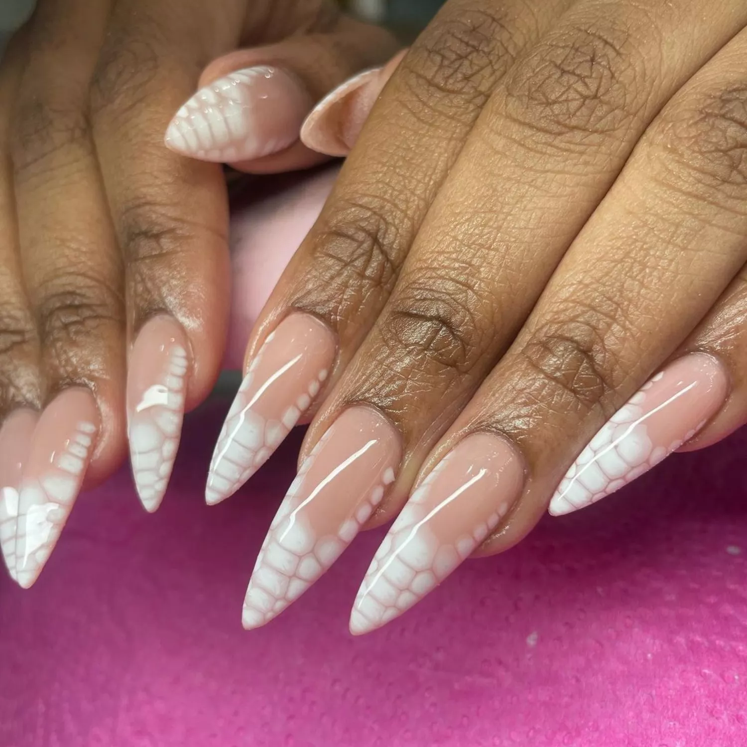 Natural nails with white snakeskin airbrushed tips