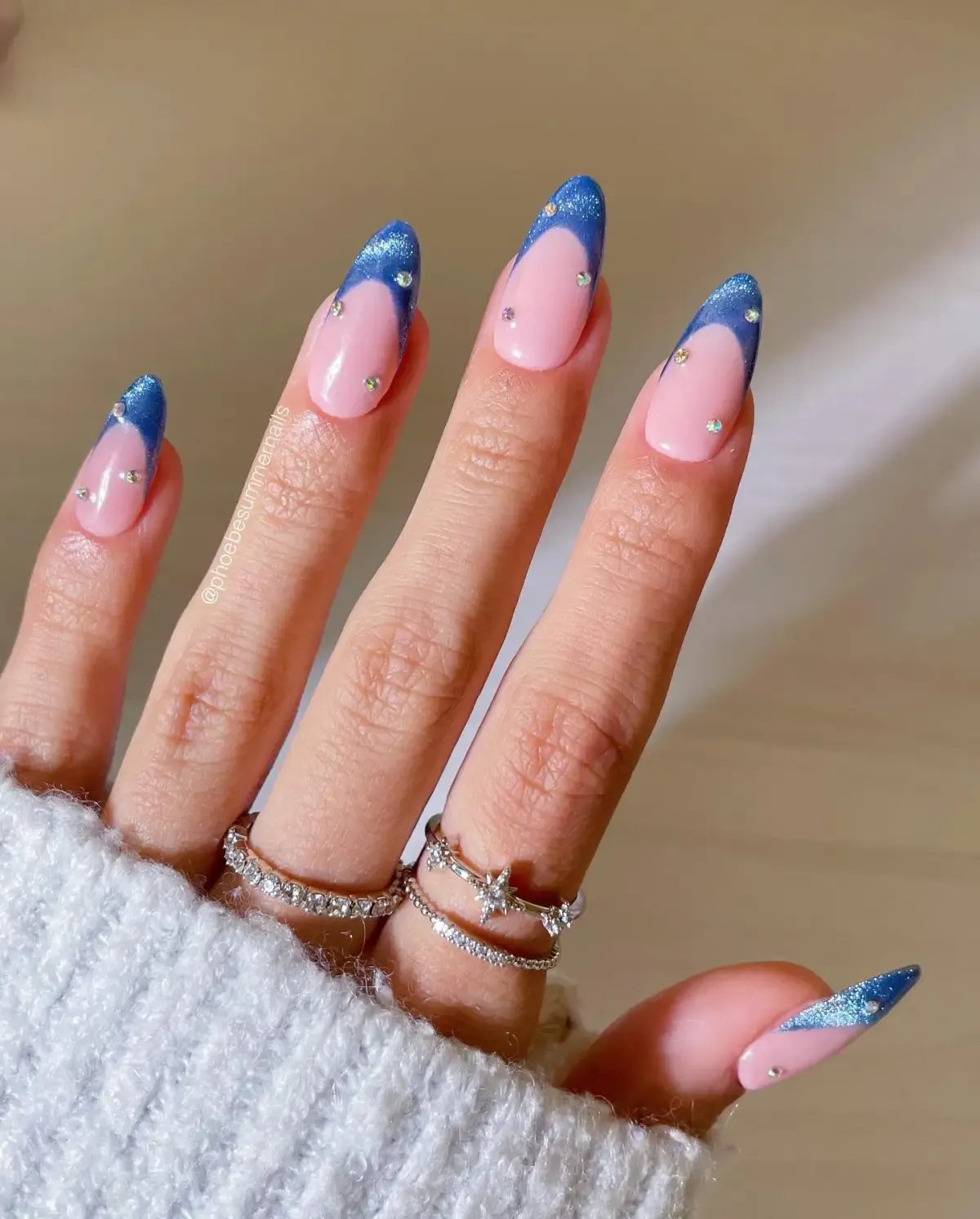 Light blue velvet French tip nails with crystals.