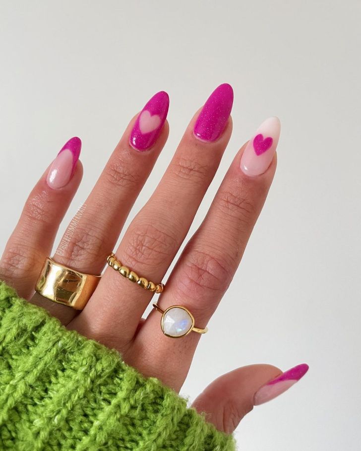 cute mismatched glitter pink Valentines nail designs with heart accents and French tips on two fingers