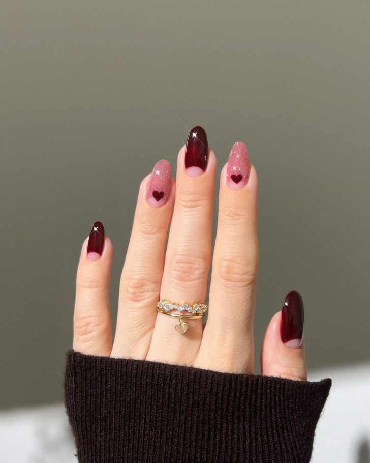 cute glitter pink and burgundy red Valentines Day nails with mini heart designs near the cuticle