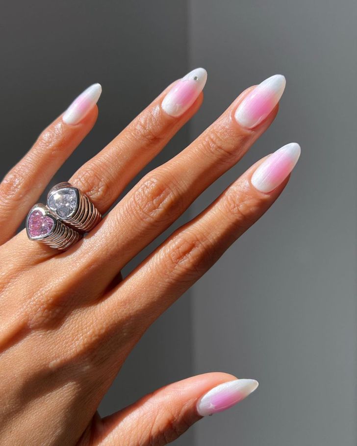 long pearly white and pink blushing aura nails with a subtle rhinestone and star design