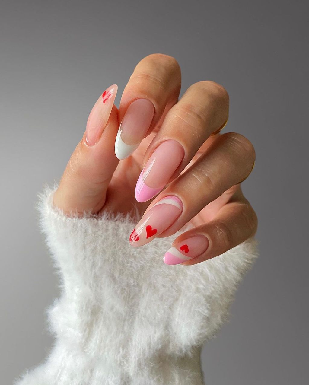 cute pink and white french tip Valentines Day nail designs with red heart art accents