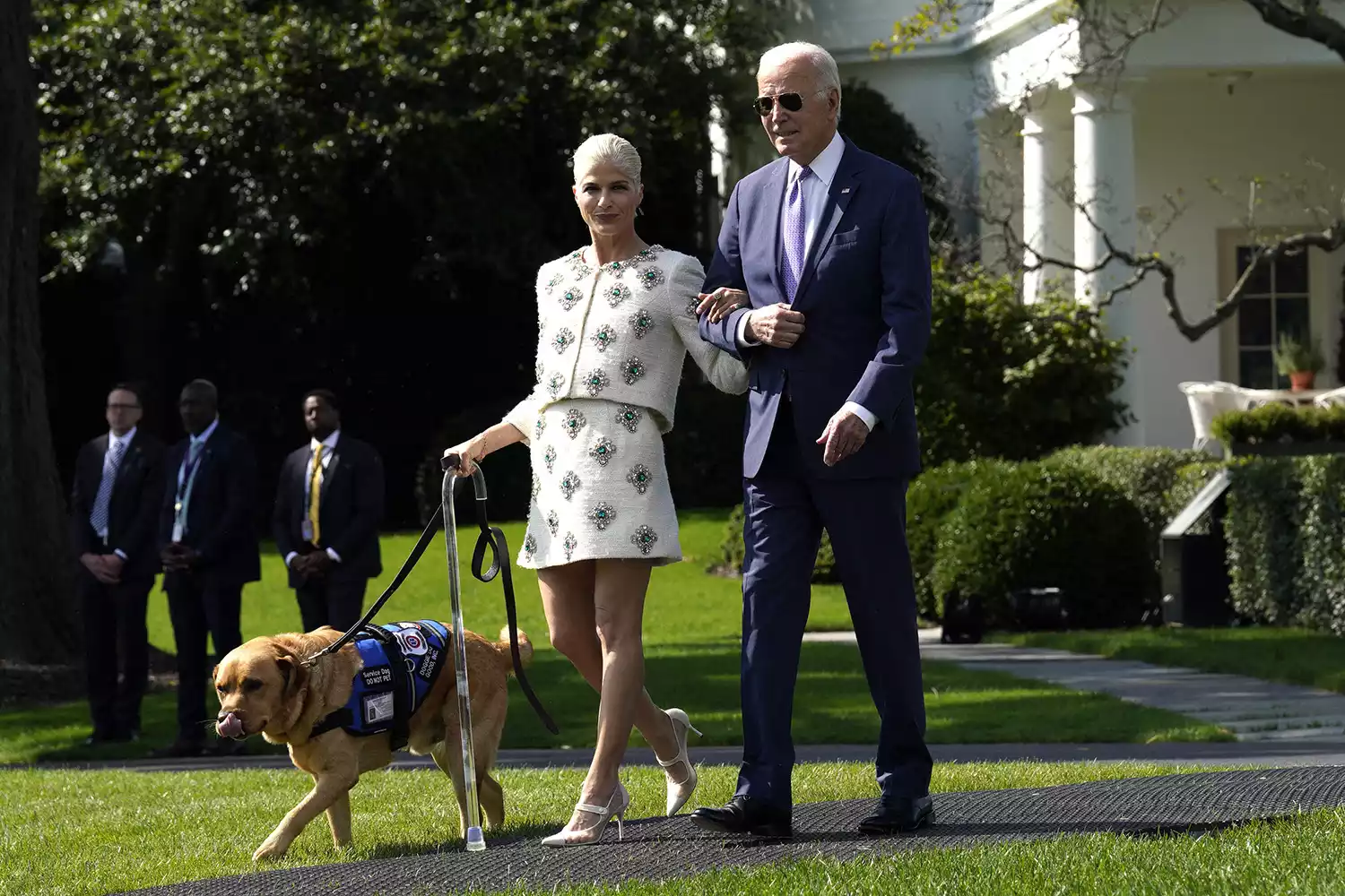 US President Joe Biden with advocate Selma Blair and her service dog arrive for the ADA + Disability Awareness Month Remarks on the South Lawn of the White House in Washingto