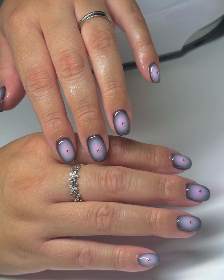 short black and pink aura nails design with rhinestone detail in the center of each nail