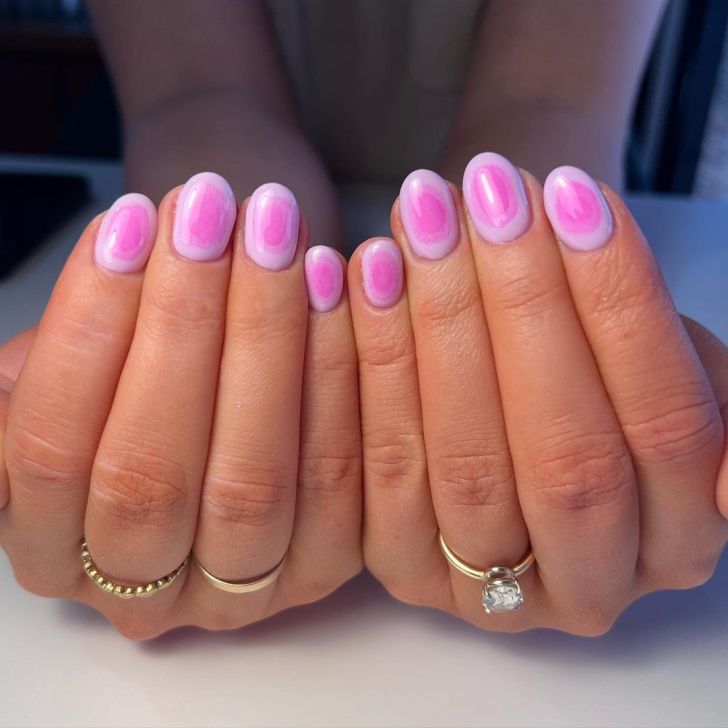 short pink DIY aura nails that are light on the outside and get darker toward the center